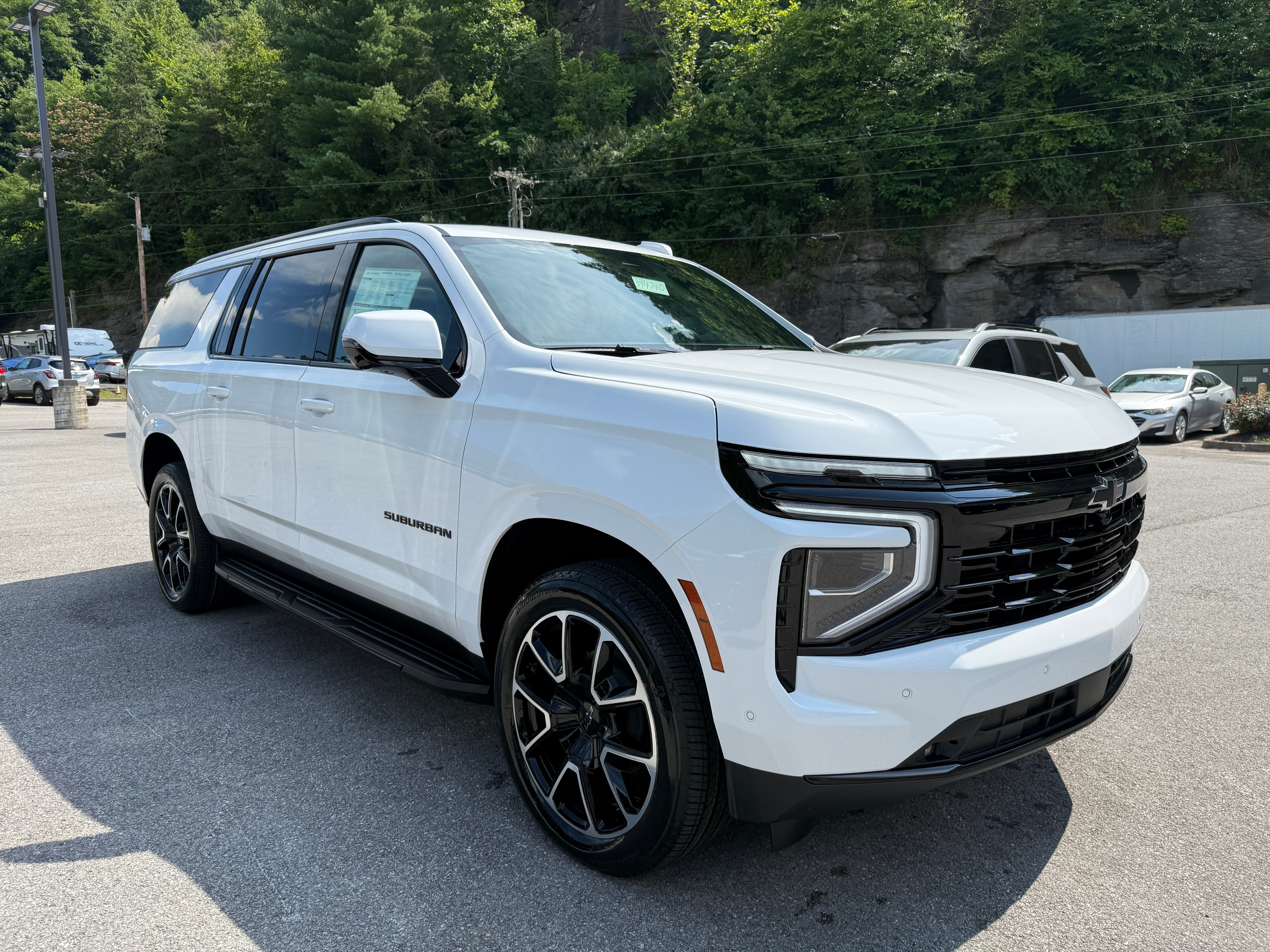 2026 Chevrolet Suburban RST in Summit White — front three-quarter view