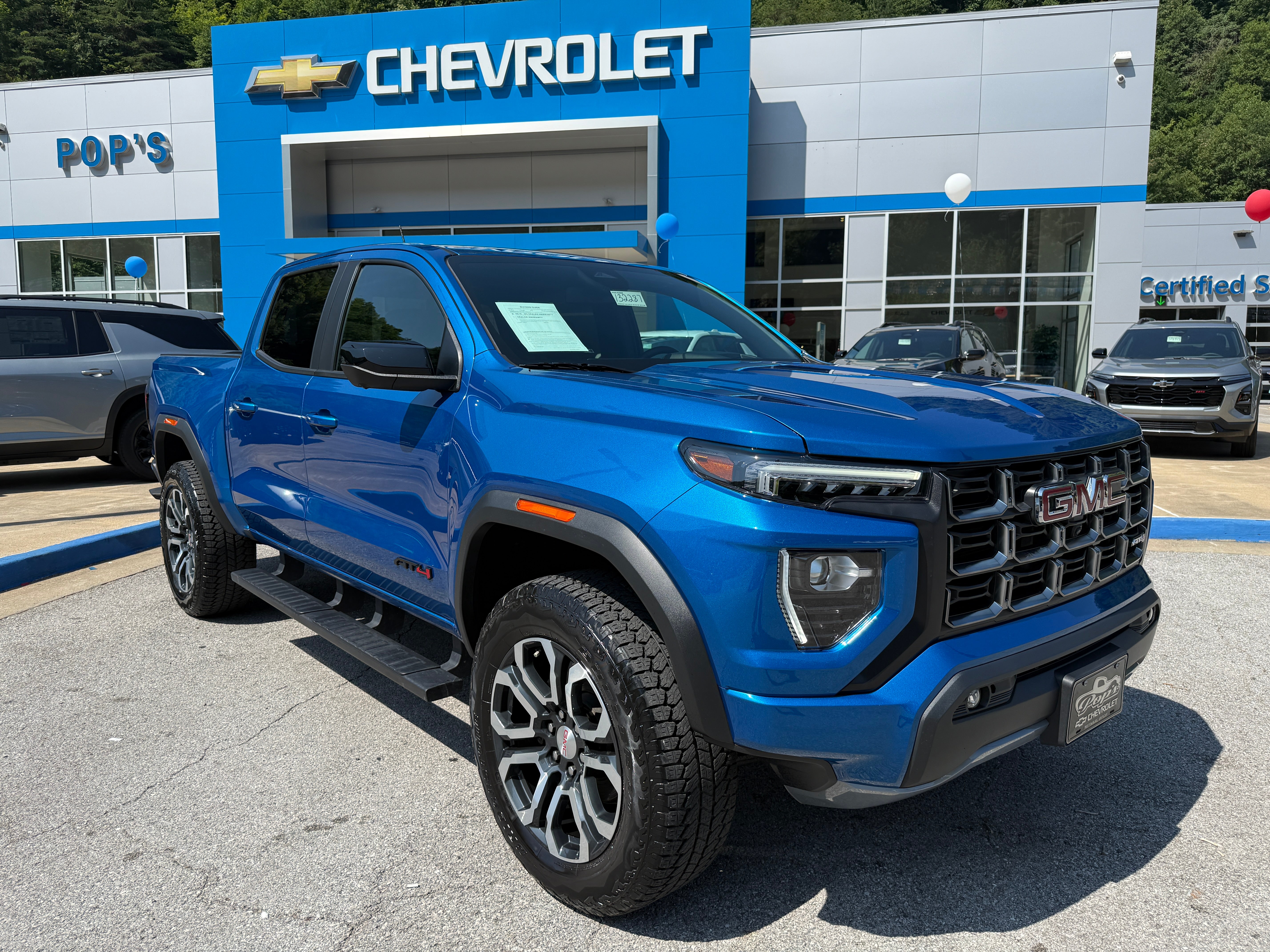 2024 GMC Canyon AT4 in Dynamic Blue Metallic — front three-quarter view