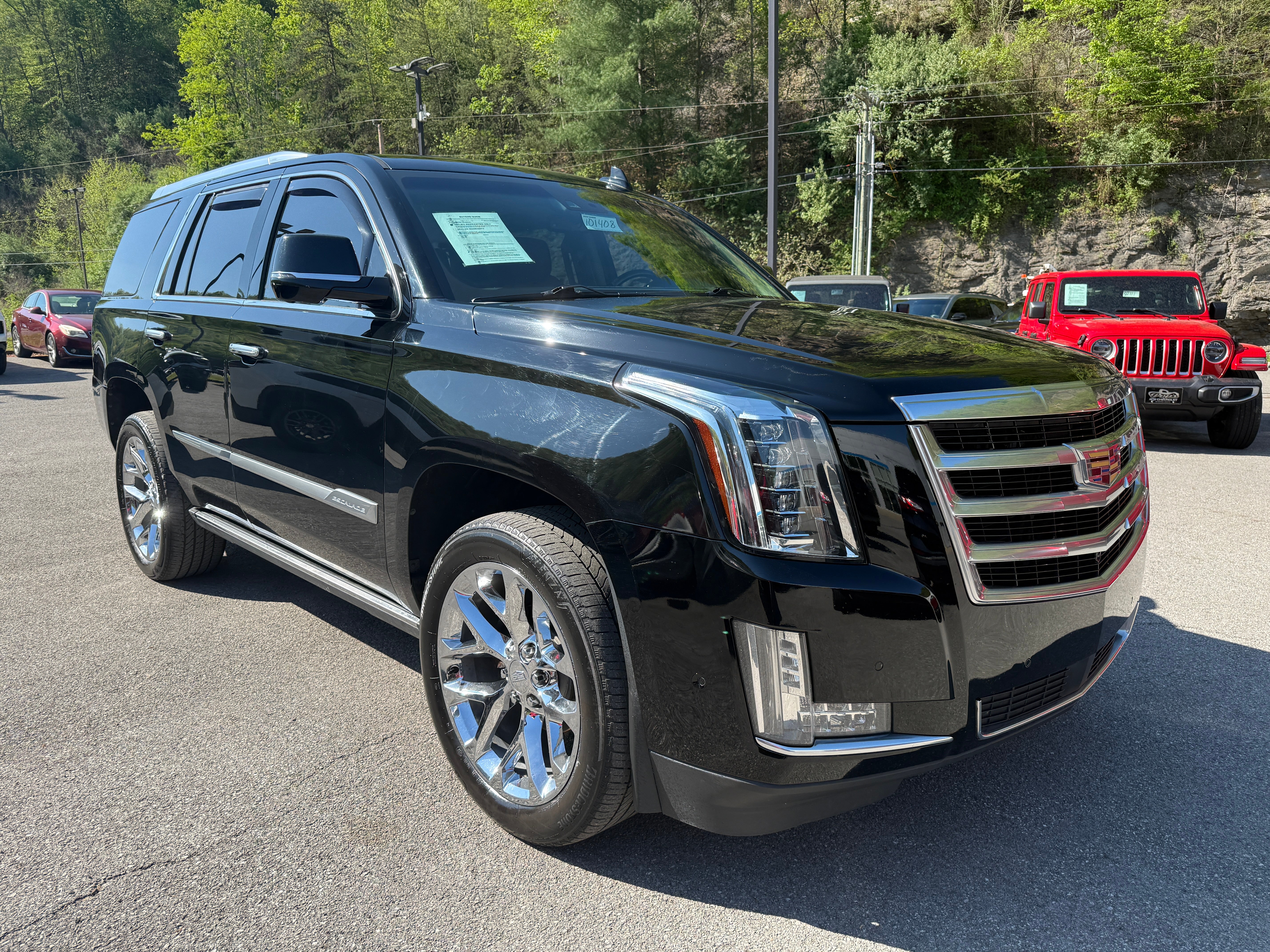2019 Cadillac Escalade Premium Luxury in Black Raven — front three-quarter view