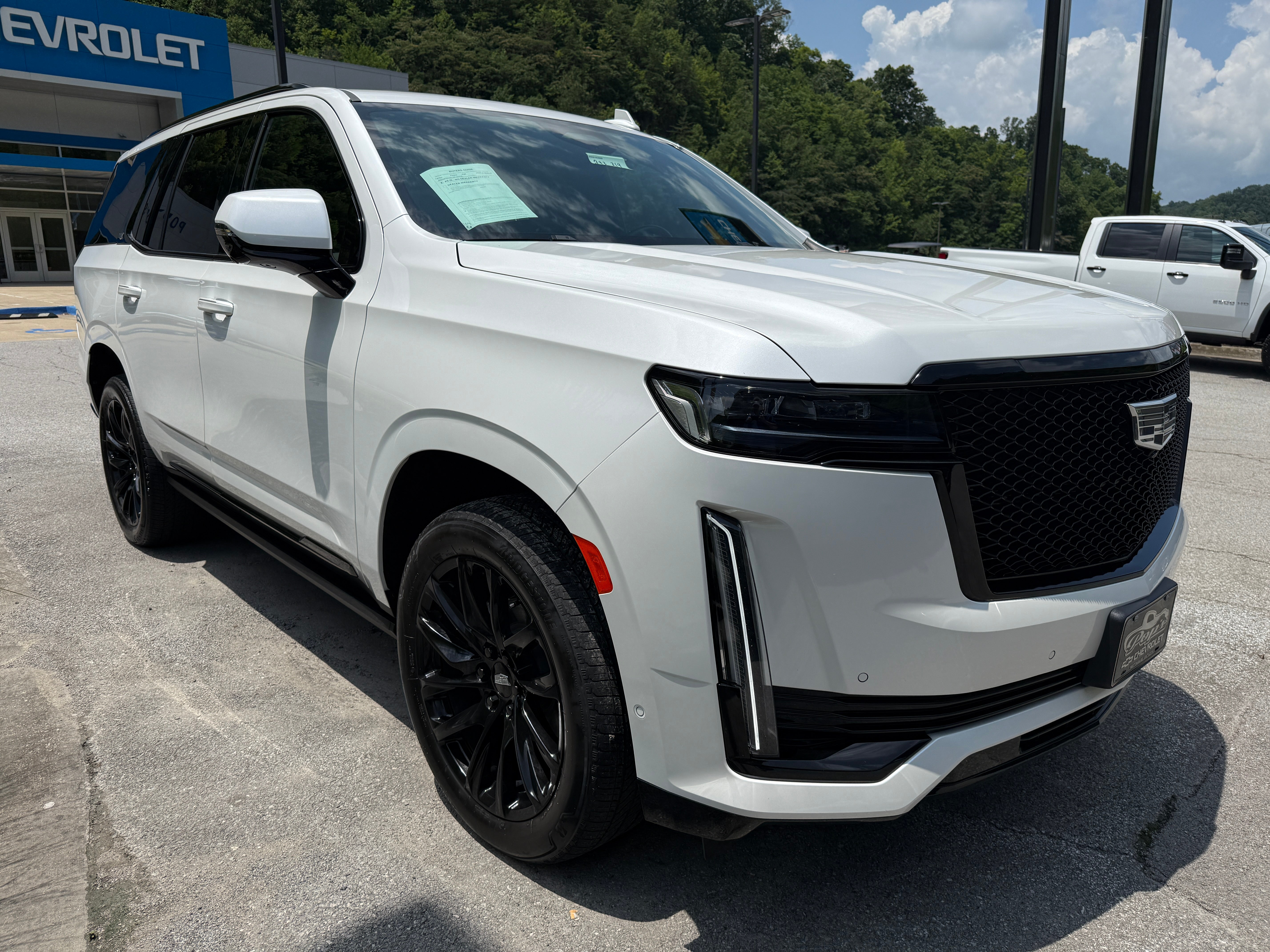 2024 Cadillac Escalade Sport in Crystal White Tricoat — front three-quarter view