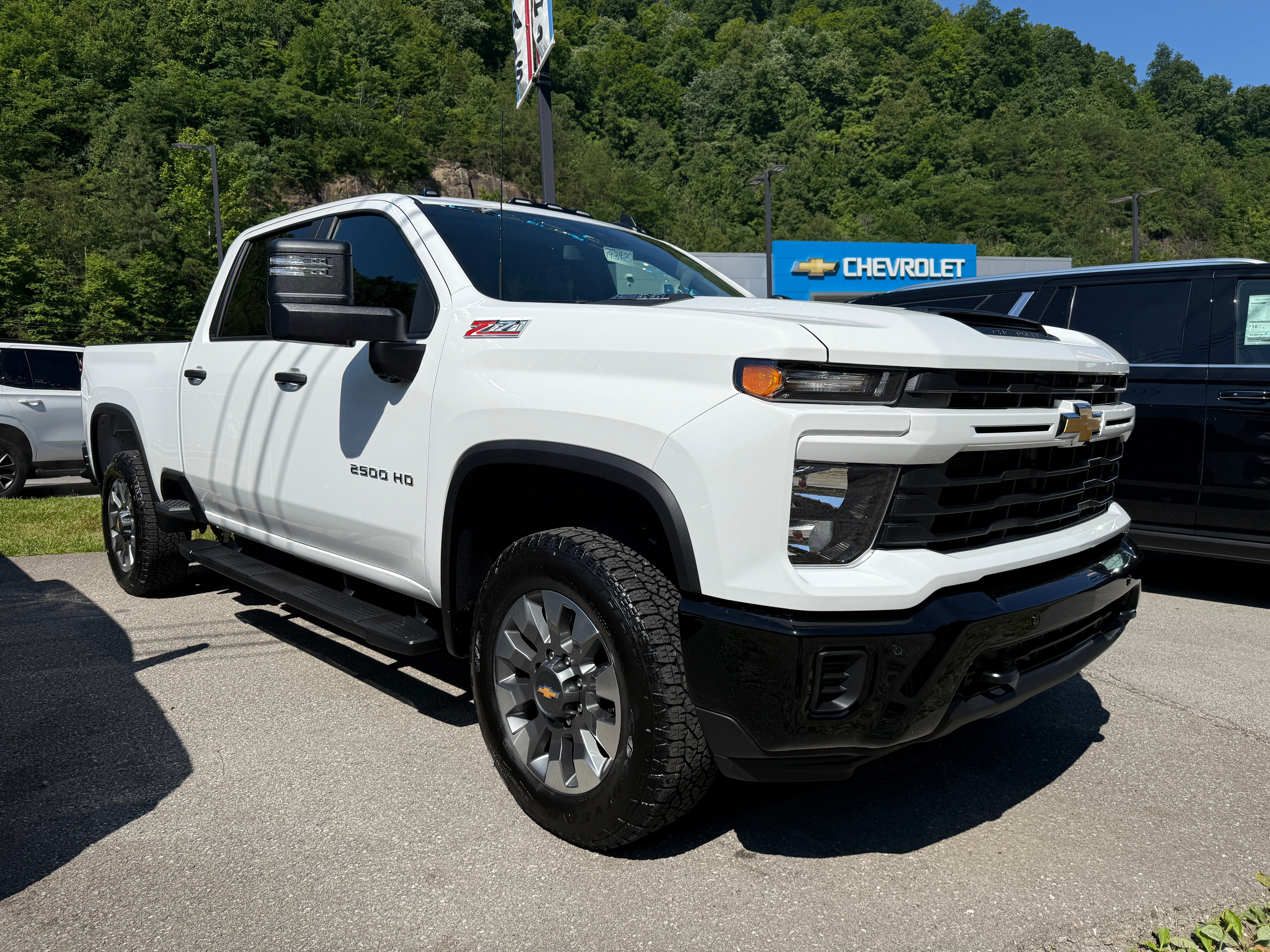 2026 Chevrolet Silverado 2500 HD Custom in Summit White — front three-quarter view