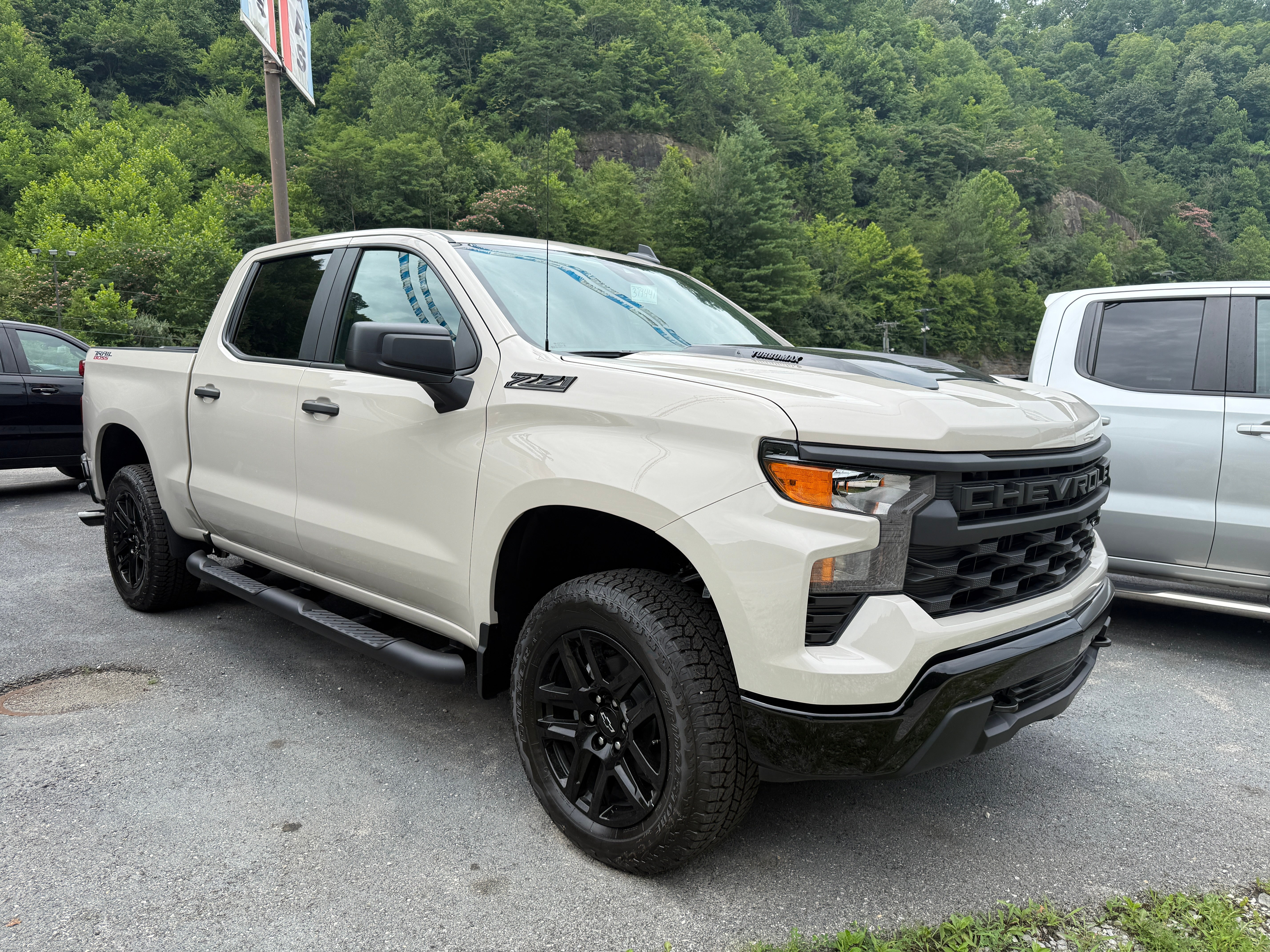 2026 Chevrolet Silverado 1500 Custom Trail Boss in White Sands — front three-quarter view
