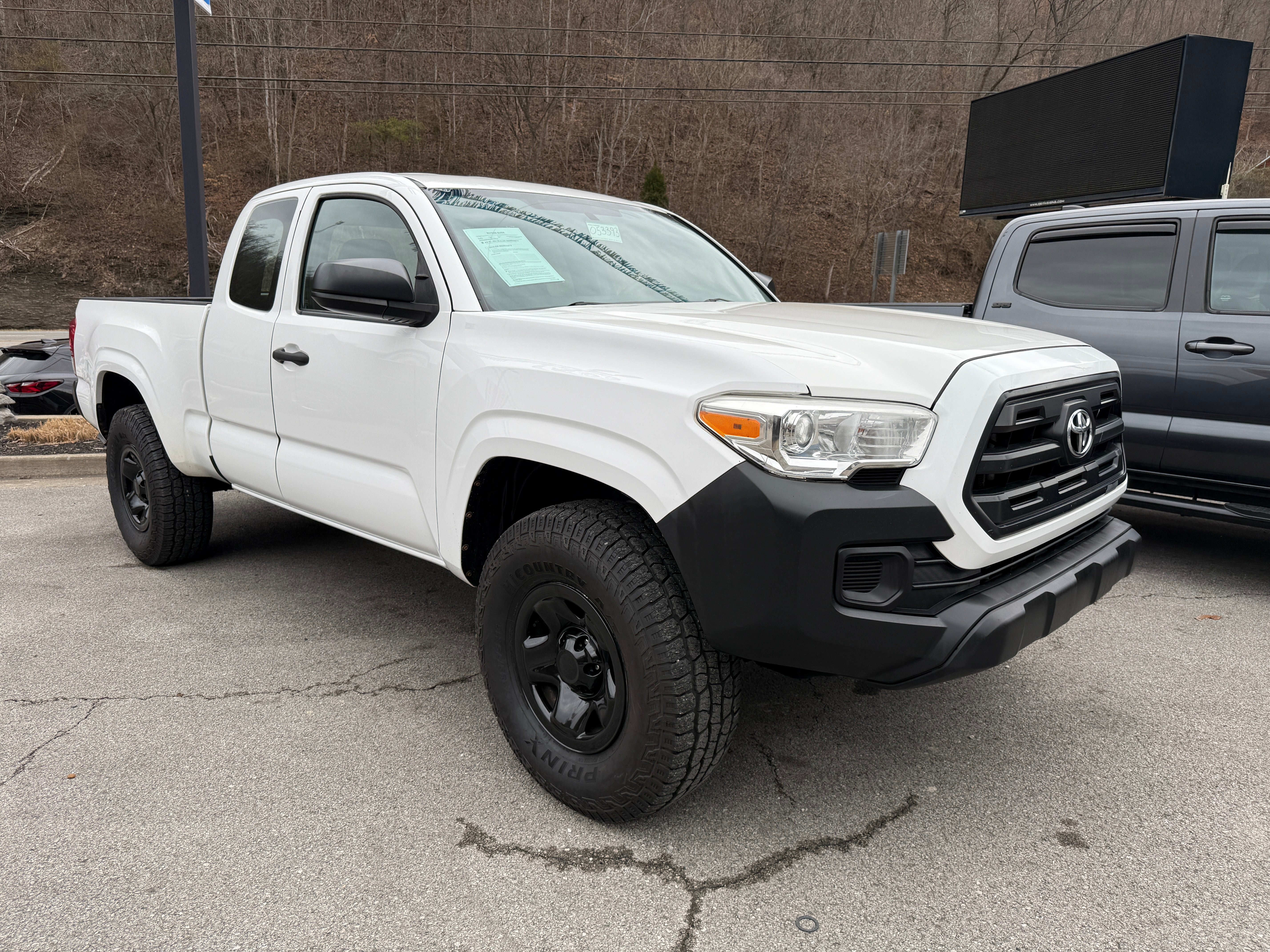 2017 Toyota Tacoma SR in White — front three-quarter view