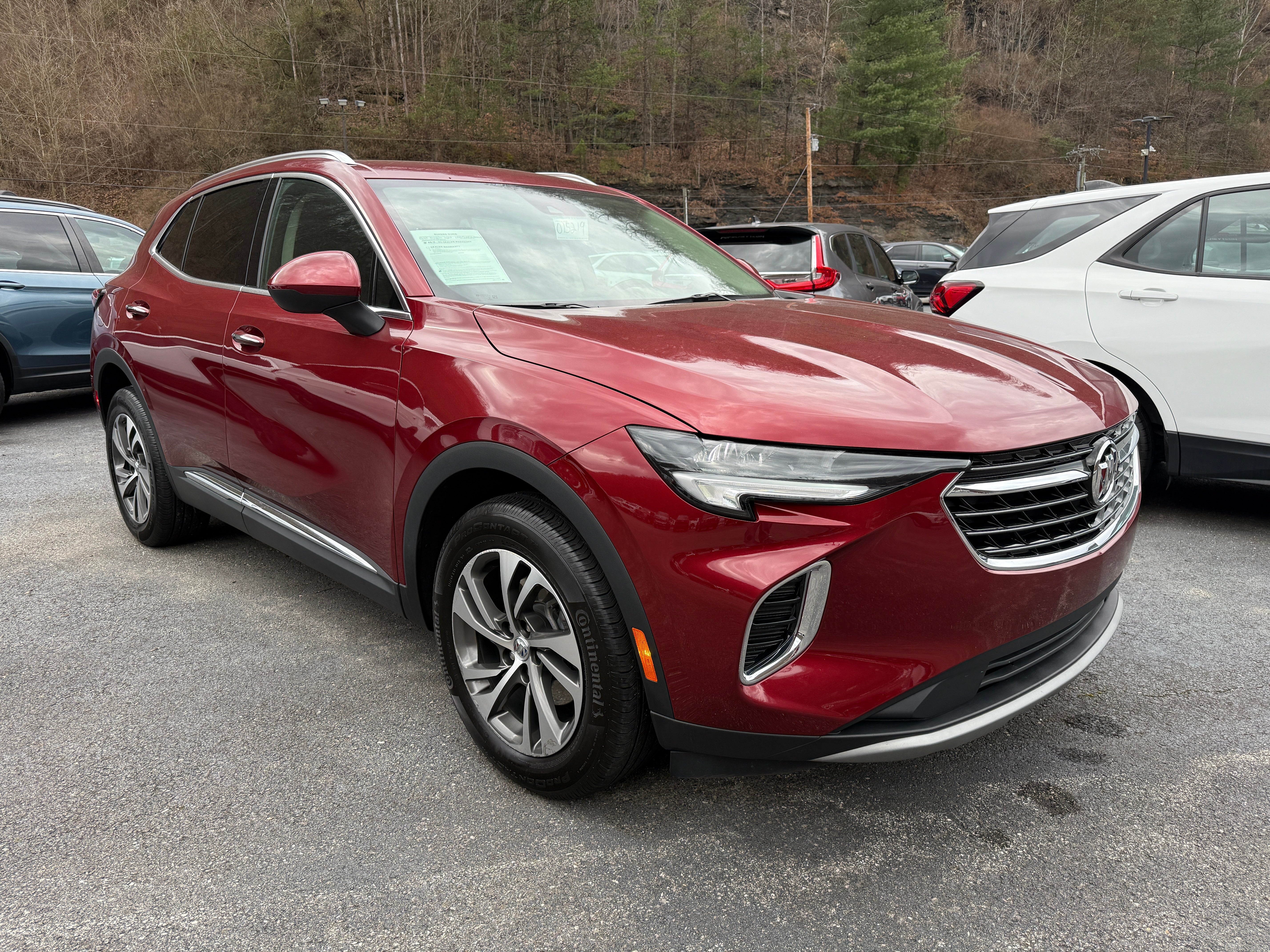 2023 Buick Envision Essence in Cinnabar Metallic — front three-quarter view